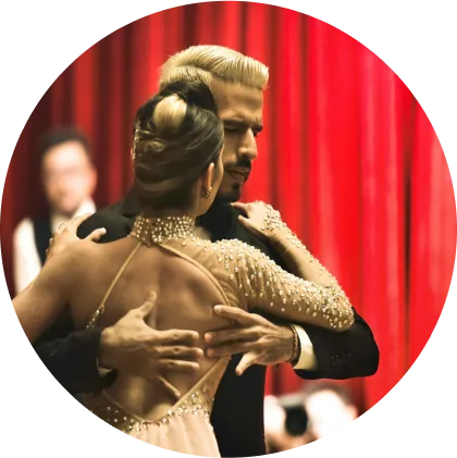 A couple gracefully performing a dance in a grand ballroom, with exquisite chandeliers and an inviting atmosphere.