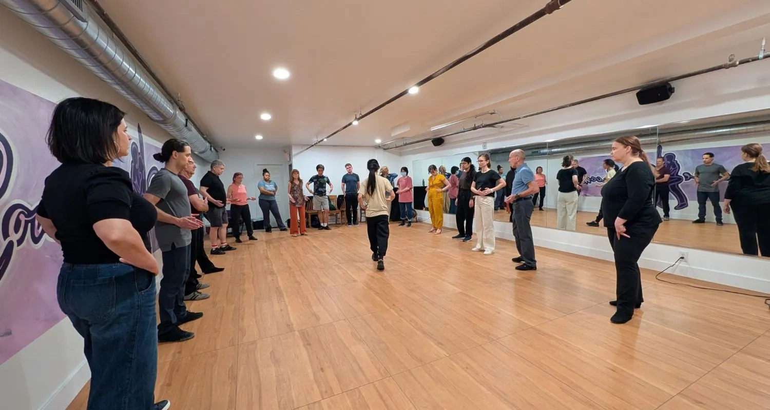 Beginners lined up across the studio during dance classes for adults at Concierge Ballroom